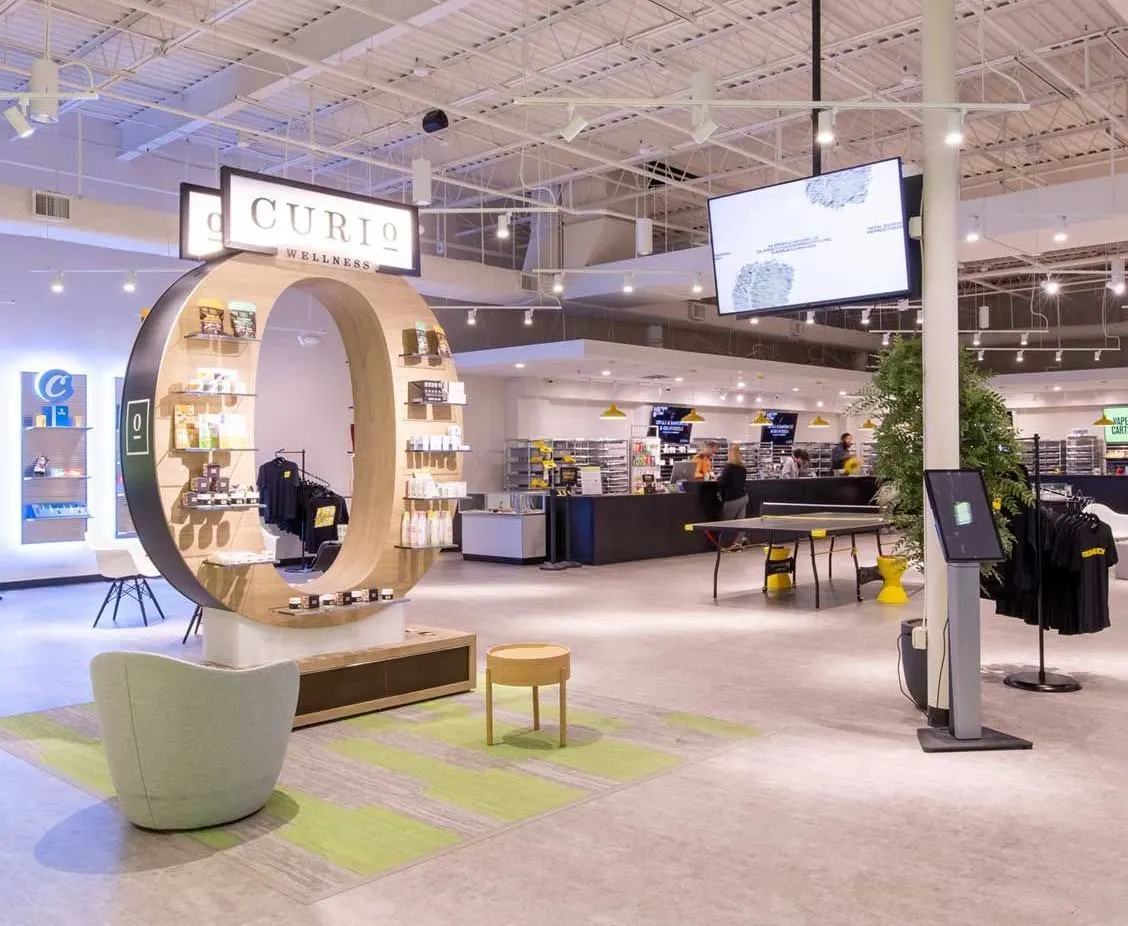 Spacious dispensary showroom with circular Curio product display and seating
